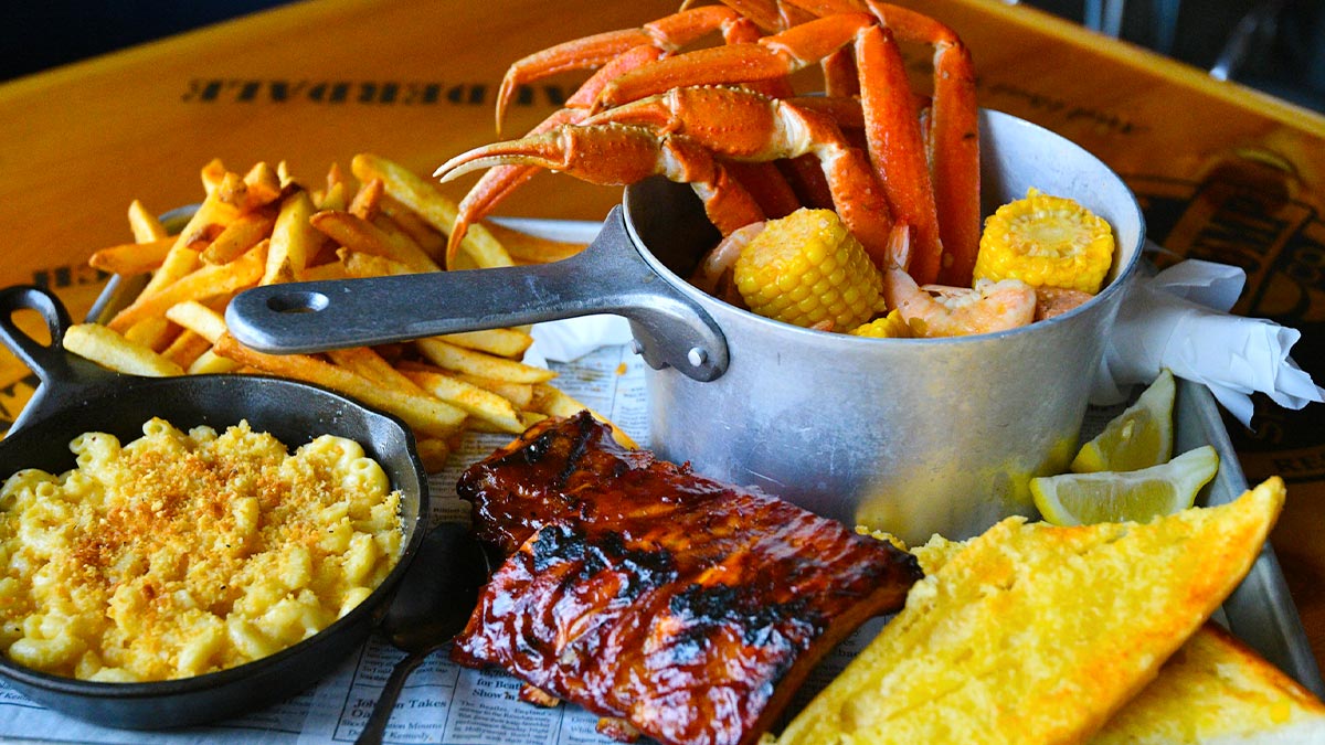 close up of food on metal tray on wooden table at Bubba Gump Shrimp Co Food in Long Beach, California, USA